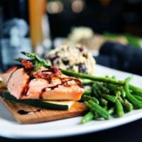 Cedar Plank Scottish Salmon · Topped with balsamic glaze, grilled zucchini, sauteed asparagus and sun-dried tomatoes.