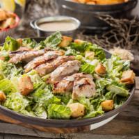 Chicken Caesar Salad · Crisp romaine lettuce tossed in Caesar dressing topped with sliced, grilled chicken breast.