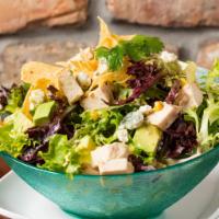 Southwest Chopped Chicken Salad · Crisp greens tossed with avocado, roasted sweet corn, bleu cheese crumbles, and crispy torti...