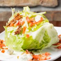 Wedge Salad · Iceberg wedge, Applewood smoked bacon, candied pecans, bleu cheese crumbles, tomatoes and ap...