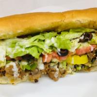 Philly Steak and Cheese Sub · Chopped steak mixed with onions and green peppers, mojo sauce topped with melted cheese.