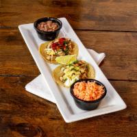 Grilled Chicken Taco Plate · Three tacos topped with cabbage, pico de gallo, red salsa  and guac served with rice and bea...
