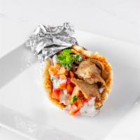 Gyro Pita · Grilled lamb and beef combination gyro slices w/ a mix of (tomatoes, onions, parsley) and tz...