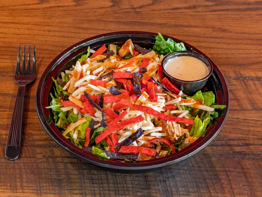 Buffalo Chicken Salad · House salad blend, grilled chicken breast, Buffalo sauce, shredded cheese, and tortilla strips with your choice of dressing.