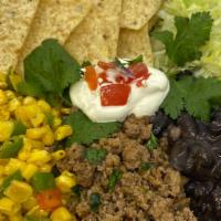 Mexican Taco Bowl · Roasted corn, black beans, seasoned ground beef, shredded lettuce, shredded cheddar cheese, ...