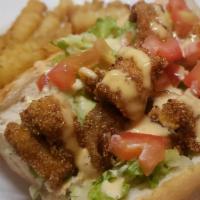 Cajun catfish po’boy w/ fries  · Our Cajun catfish nuggets with lettuce and diced tomatoes, drizzled with our secret sauce on...
