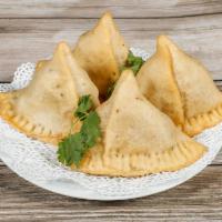 Samosa · Crispy pastry filled with mildly spiced potatoes and peas.