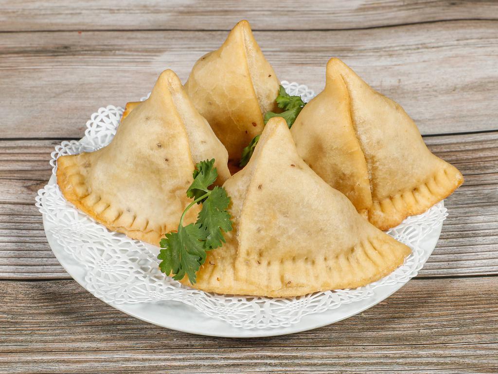 Samosa · Crispy pastry filled with mildly spiced potatoes and peas.