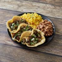 Taco Dinner · Three tacos with steak or chicken. Served with rice, refried beans and your choice of corn o...