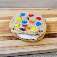 M&M Avalanche Cookie · 2 M&M cookies with white buttercream frosting in between.