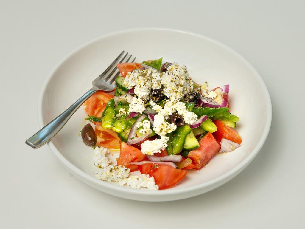 Traditional Greek Salad · Tomatoes, red onions, green peppers, cucumbers, Kalamata olives, feta cheese and extra virgin olive oil.