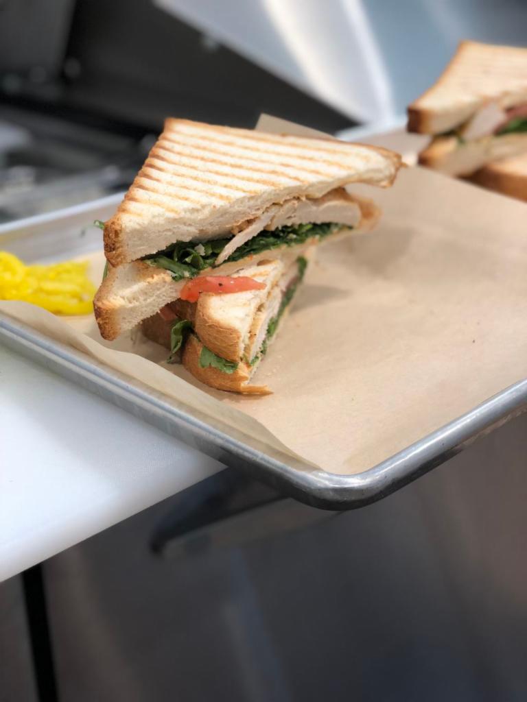 Elia Signature Sandwich · White or wheat toast with arugula, tomatoes, spicy feta spread and grilled chicken.