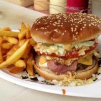 Hamburguesa Q'Sabroso · 7 oz. burger with white cheese, ham, yellow American cheese, potato chips, cabbage, garlic s...