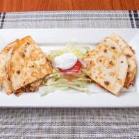 Quesadillas de Queso · Giant flour tortilla stuffed with cheese and a side of sour cream.