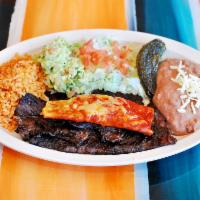 Tampiquena · Traspasada signature steak dinner. 12oz steak with a red cheese enchilada. 
served with rice...