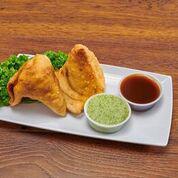 Vegetable Samosas · 2 pieces. Crispy puffs stuffed with potatoes and peas. Served with homemade mint and tamarin...
