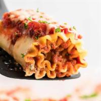 96. Beef Lasagna Rolls · Meat stuffed pasta in marinara sauce with melted mozzarella. Served with Caesar salad and ga...
