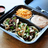 Taco Plate · Three tacos on hand made tortillas, served with rice, beans and chips.