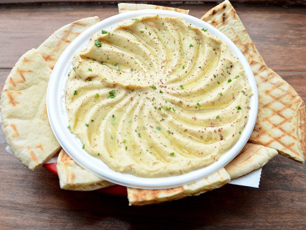 Original Hummus · A smooth blend of ground chickpeas, tahini sauce, lemon and a hint of garlic topped with olive oil, served with a grilled pita. Vegan.