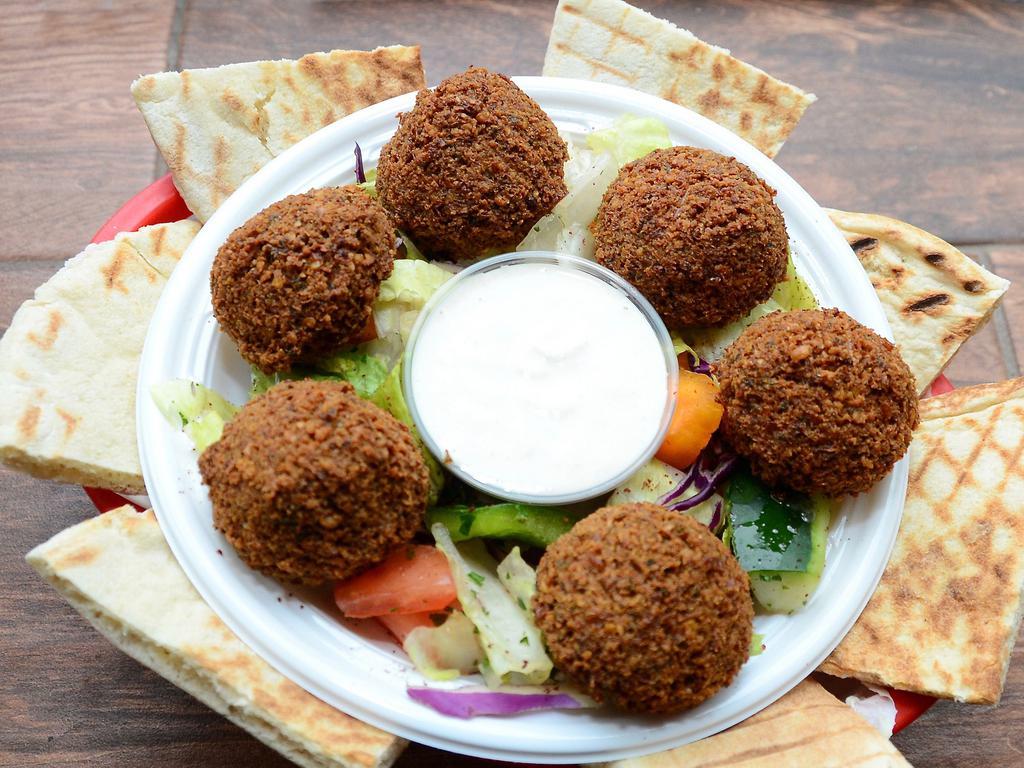 Falafel Appetizer · 6 pieces of falafels are served on a bed of house salad, with a side of tahini and a grilled pita bread. Vegan.