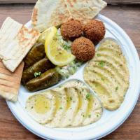 Vegetarian Assrotment · A combination plate of hummus, baba ghanouj, dolmas, falafels, and choice of salad, served w...