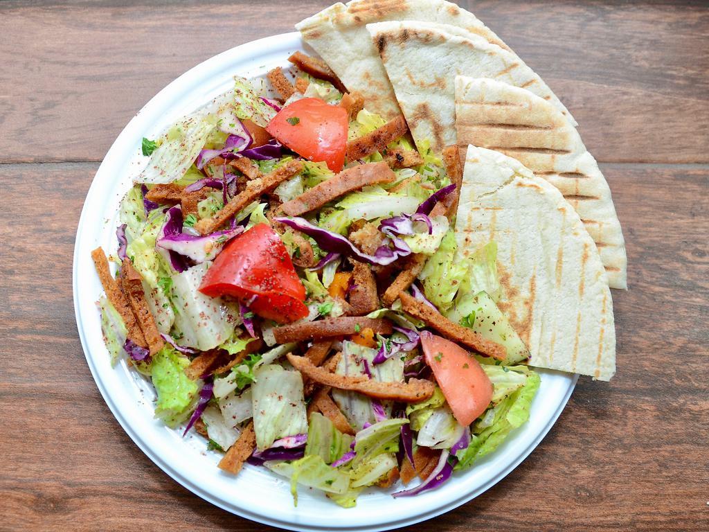 Fattoush Salad · Chopped lettuce, tomato, cucumber, pita chips, green and red pepper, sumac, mixed with olive oil and lemon juice. Vegan.