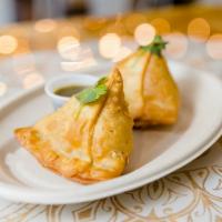 Samosas · Two crispy pastries stuffed with potatoes, peas, and secret spices.  
Served with a tamarind...