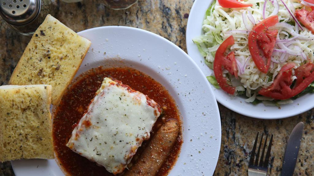 Lasagna Sausage Dinner · Lasagna noodles layered with ricotta cheese and beef, marinara sauce and mozzarella with a side of sausage. Includes a small fantastic salad. 
