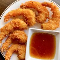 Coconut Shrimp  · Deep-fried shrimp rolled in coconut flakes and rice batter to a delicious crisp. On side wit...