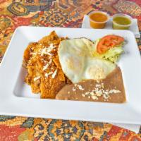 Chilaquiles  · Corn tortilla chips sauteed in sauce, cheese, 3 eggs over easy, and beans.