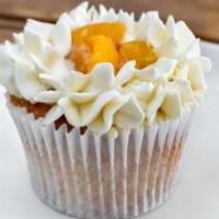Peach Cobbler Cupcake · Peaches inserted with buttercream frosting.