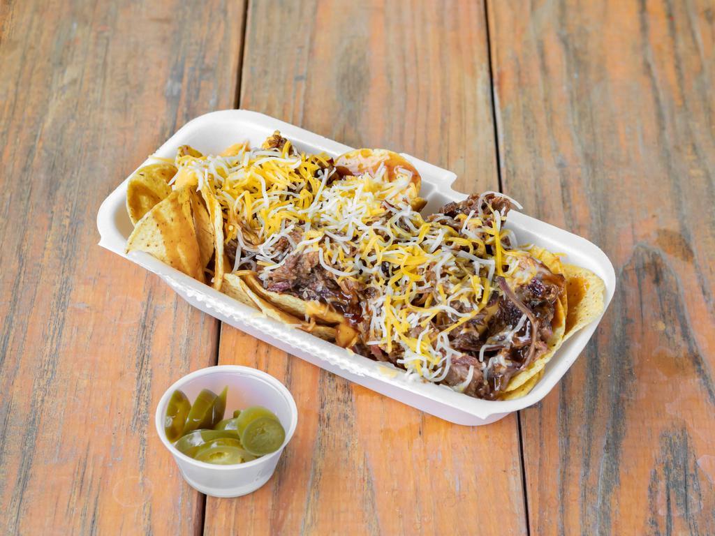 Carlton's Nachos  · A pile of corn tortilla chips topped with queso, chopped brisket, sauce, and grated cheese. Jalapenos on the side!