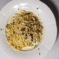 Spaghetti Carbonara · spaghetti, peas, crispy bacon, farm eggs and pecorino cheese with light cream sauce.