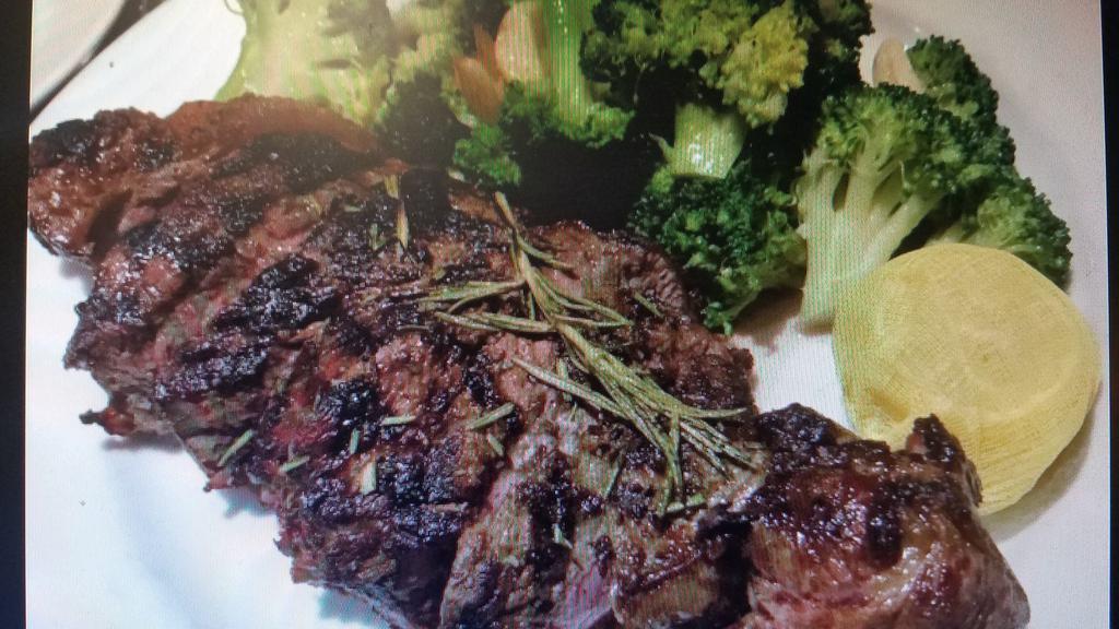 New York Choice Steak · Hand-cut marinated steak in rosemary oil, char grilled sliced, broccoli, and roasted potatoes.