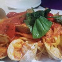 Spaghetti al Frutti di Mare · Fresh shrimp, clams, calamari and seasoned fish red sauce with herbs.