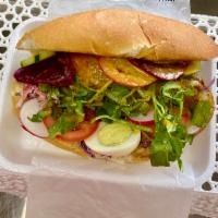 French bread and chicken  · Mayonnaise and mustard spread, cabbage slaw, tomatoes, cucumbers, beets, slices of radish, w...
