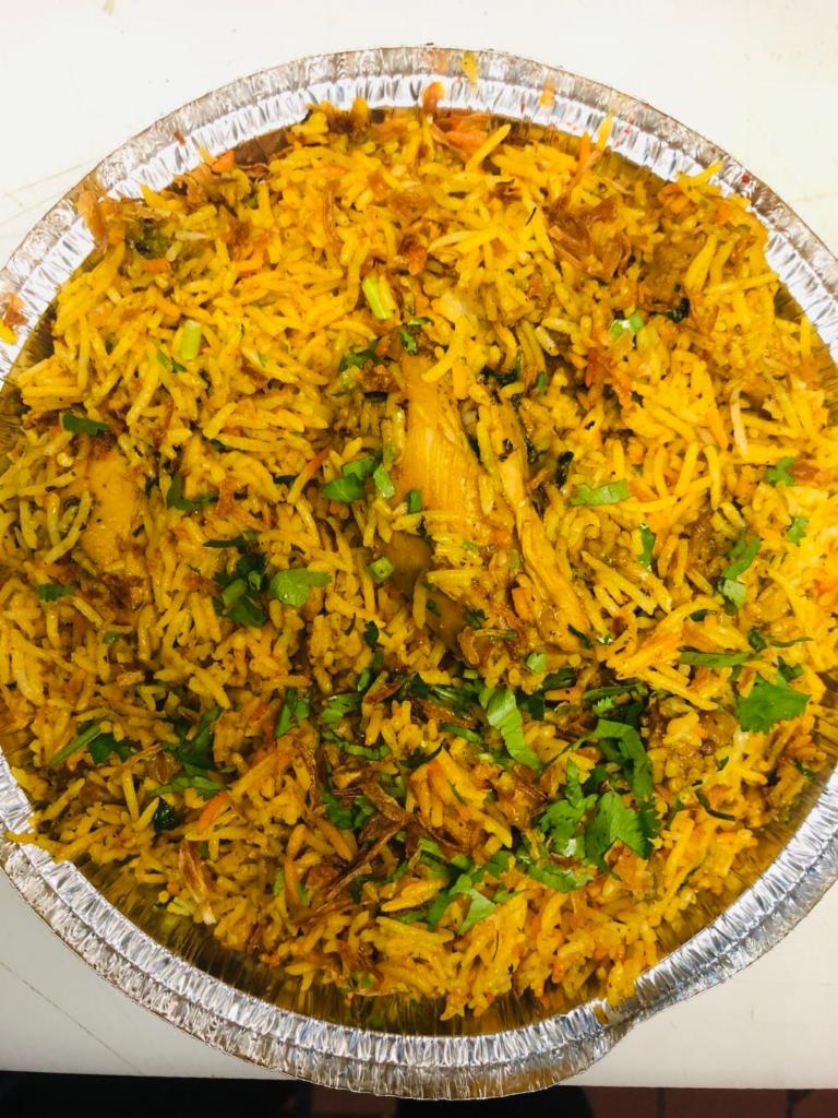 Chicken Biryani · Basmati rice slow cooked and layered with chicken.