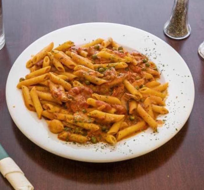Penne alla Vodka Special · Mushroom, peas and prosciutto in a pink sauce.