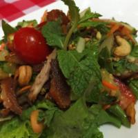 Yum Crispy Duck · Pineapple and apple, cashew nuts, peanut and red onion with chili lime dressing. Spicy.