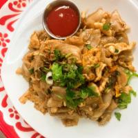 Kua Gai · Flat noodle, chicken, egg, scallion, squid served with Sriracha sauce.