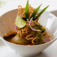 Chicken Kao Soy · Northern Thai style egg noodle in curry broth, pickled mustard, red onion with crispy noodle...