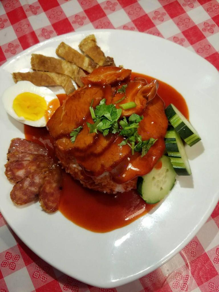 Roasted Pork & Crispy Pork · With boiled egg, Thai sausage, red gravy sauce & Jasmine rice. (Contain sesame)