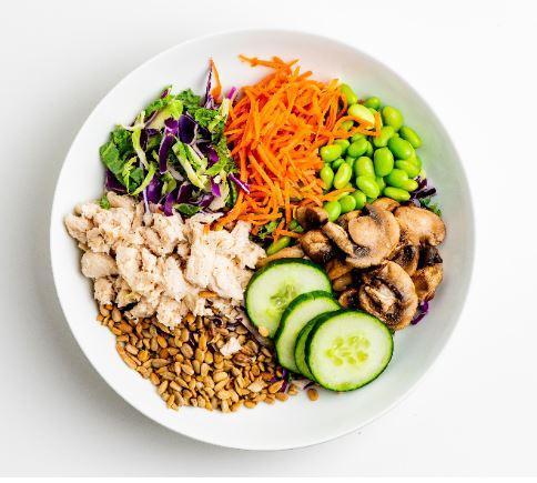 SVK Protein Punch Bowl · Chicken breast, mixed greens, shredded cabbage, roasted shrooms, edamame, pickled carrots, cucumber, toasted sunflower seeds, feta and Sriracha Ranch dressing. (Gluten free)