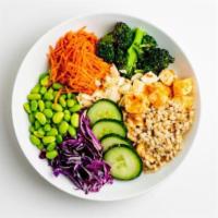 SVK Buddhas Bowl · Herbed barley topped with chili garlic tofu, shredded cabbage, edamame, pickled carrots, roa...