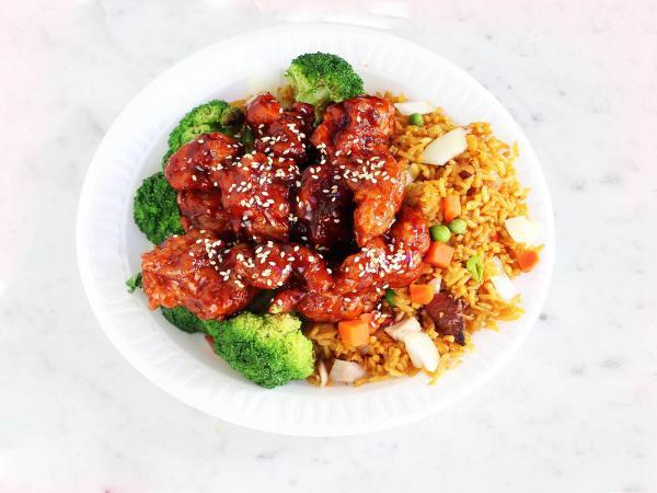 S5. Sesame Chicken Special · Chunks of chicken with brown sauce and broccoli with sesame seeds on the top.