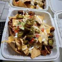 Chorizo Nachos · House Chips Topped with Grilled Chorizo, Black Beans, Homemade Queso, Sour Cream, Chipotle S...