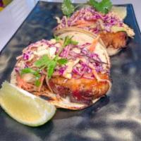 Pork Belly Taco · Braised Pork Belly then Grilled, Topped with Chipotle Slaw, Raw Onions and Cilantro