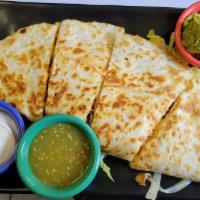 Al Pastor quesadilla · Grilled pork pastor meat with pineapple, melted cheese, served with red salsa, guacamole and...