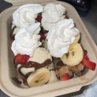 Churro Split · 2 full Churros topped with Ice Cream. strawberries, bananas, Nutella, and whipped cream.