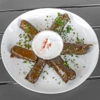 Dolmas -Grape leaves (4 pieces)  GF & Vegan) · Stuffed grape leaves with rice and herbs. Served with Tzatziki sauce